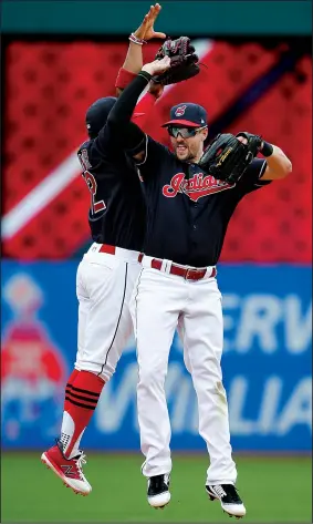  ?? AP/RON SCHWANE ?? Lonnie Chisenhall (right) and Francisco Lindor celebrate after Wednesday’s 5-3 victory over the Detroit Tigers in Cleveland. It was the Indians’ 21st consecutiv­e victory, the longest winning streak ever by an American League team.