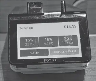  ?? STU NEATBY • THE GUARDIAN ?? Some newer models of debit machines include tipping options.