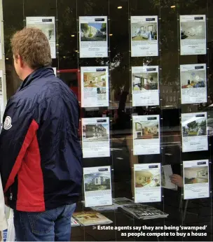  ??  ?? > Estate agents say they are being ‘swamped’ as people compete to buy a house