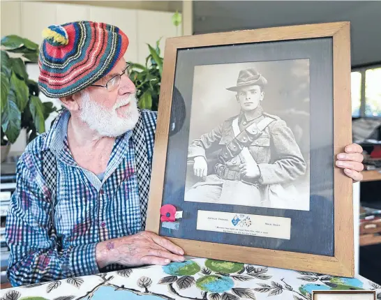  ?? Photo: NICOLE JOHNSTONE/FAIRFAX NZ 630714774 ?? Invercargi­ll man Brian McNaughton holds a portrait of his uncle Arthur Parker, who was killed after saving more than 30 men in one day at Gallipoli.