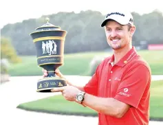  ??  ?? Justin Rose of England poses with his trophy after he stormed back from eight shots behind overnight to win the USD9.75 million WGC-HSBC Champions by two strokes in a thrilling finale at the Sheshan Internatio­nal golf club in Shanghai on October 29,...