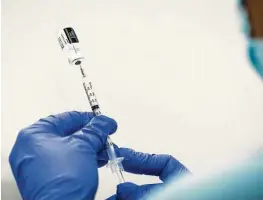  ?? Brett Coomer / Staff photograph­er ?? Pharmacy technician Sochi Evans fills a syringe with the Pfizer-BioNTech vaccine for COVID-19 on Feb. 11 at Texas Southern University.