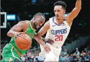  ??  ?? Boston Celtics guard Kemba Walker drives against Los Angeles Clippers guard Landry Shamet (20) during a Feb. 13 game in Boston. The ex-UConn great missed only six games in eight seasons in Charlotte, but missed his 10th game this season on Tuesday night when the Celtics continued their West Coast trip at Portland.