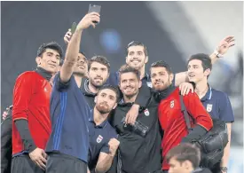  ??  ?? Iran players take a selfie after their victory over Qatar on Thursday.