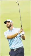  ?? Elsa / Getty Images ?? Dustin Johnson plays a shot on the 18th hole on Sunday.