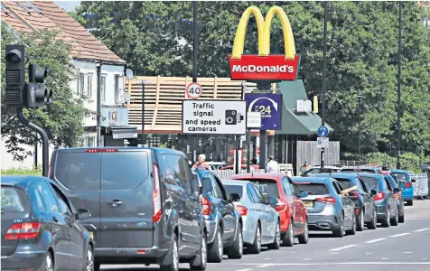  ??  ?? In the fast-food lane: cars queuing for Mcdonald’s: Tanya Gold, below, says legislatio­n is need to tackle obesity