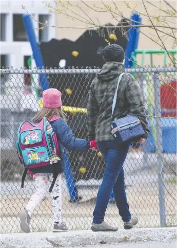  ?? ADRIAN WYLD / THE CANADIAN PRESS FILES ?? A woman walks her daughter to school in Gatineau, Que., in mid-May. Former Conservati­ve leadership
candidate Leslyn Lewis says she strives to be a better parent than she was before the pandemic.