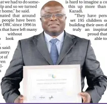  ??  ?? Kalamba Donatien Kazadi with his Credit Unions of Wales Award