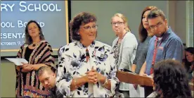  ?? / John Popham ?? Principal Kristin Teems (center) recognizes the faculty and staff from East Central Elementary School at the Rome City Board of Education meeting on Tuesday night.