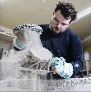  ?? (AP/Flathead Beacon/Hunter D’Antuono) ?? Matthew Howard coats a mold with sand Nov. 5 at Kalispell Art Casting in Evergreen, Mont.