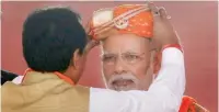  ?? PTI ?? A BJP leader felicitate­s Prime Minister Narendra Modi during an election rally in Lunawada, Panchmahal district, on Saturday. —