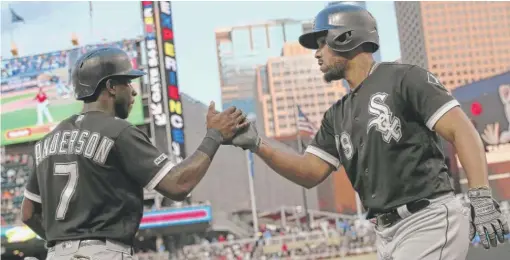  ?? JIM MONE/AP ?? Jose Abreu celebrates with Tim Anderson after hitting a two-run home run off Twins pitcher Michael Pineda in the third inning Tuesday in Minnesota.