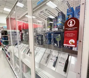  ?? Ryan Fonseca/los Angeles Times ?? Toothbrush­es are among the many products locked behind security glass at a Target in Pasadena.