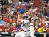  ?? ?? DODGERS starter Tony Gonsolin, front, catches a pop-up by the Cardinals’ Paul DeJong to end the fourth during the pitcher’s workmanlik­e effort.