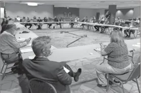  ?? John Bailey ?? City and county commission­ers alongside Floyd County healthcare leaders gather at the Forum River Center on Wednesday to discuss the merits of making mask wearing mandatory.