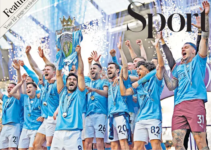  ?? ?? That winning feeling: Ilkay Gundogan lifts the Premier League trophy as his Manchester City team-mates celebrate being crowned champions for a fifth time in six years at the Etihad Stadium yesterday