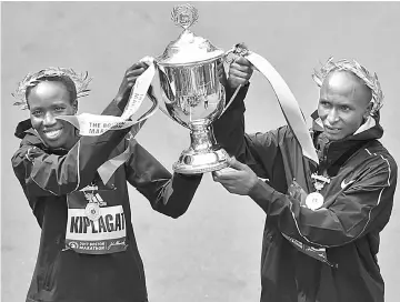  ??  ?? Boston Marathon women’s division winner Edna Kiplagat, of Kenya, and men’s division winner Geoffrey Kirui, also of Kenya, hold the trophy during the 121st Boston Marathon in Boston, Massachuse­tts, US. — Reuters photo