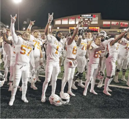  ?? BRAD TOLLEFSON/AP ?? University of Texas football players sing “The Eyes of Texas” after a game in 2018.