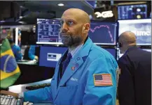  ?? AP ?? Specialist Meric Greenbaum works on the floor of the New York Stock Exchange Friday. Stocks are opening sharply lower, putting the market on track for its worst week since October 2008.