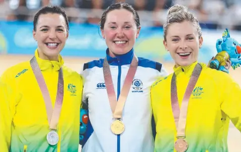  ?? Picture: PATRICK HAMILTON/AFP ?? PRIDE: Scotland's Katie Archibald (centre), Australia's Rebecca Wiasak (left) and Australia's Annette Edmondson (right) pose with their respective gold, silver and bronze medals after the women's 3000m individual pursuit final last night.