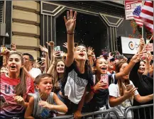  ??  ?? Young fans cheer as members of the U.S. Women’s National Soccer Team travel down the “Canyon of Heroes” in a ticker-tape parade Wednesday in New York City. The team defeated the Netherland­s 2-0 Sunday in France to win the 2019 Women’s World Cup.