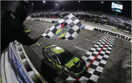  ?? (Meg Oliphant/Getty Images) ?? William Byron, driver of the #24 RaptorToug­h.com Chevrolet, takes the checkered flag to win the Cup Series Blue-Emu Maximum Pain Relief 400 at Martinsvil­le Speedway Saturday night.