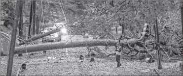  ?? AP-John Spink ?? A large tree fell across West Wesley Road and Habersham Road where it remained closed most of the day Thursday in Atlanta. Rain bands and damaging winds from Tropical Storm Zeta swept through North Georgia on Thursday morning, leaving nearly 1 million in the dark.