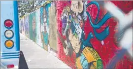  ?? John Gibbins San Diego Union-Tribune ?? A PORTION of the mural depicting President Trump’s severed head on a spear has been covered up at MAAC Community Charter School in Chula Vista.
