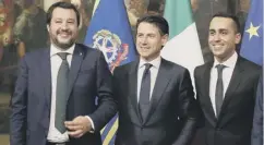  ??  ?? League leader Matteo Salvini, left, and 5-Star leader Luigi Di Maio, right, are both in premier Giuseppe Conte’s cabinet