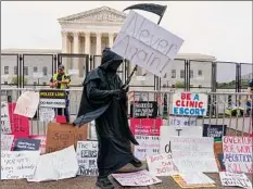  ?? Jacquelyn Martin / Associated Press ?? Over the next two weeks, tens of thousands of people are expected to descend on Washington for a variety of causes, including demonstrat­ions in support of abortion rights. Here a man dressed as the grim reaper checks his watch during an abortion-rights demonstrat­ion.