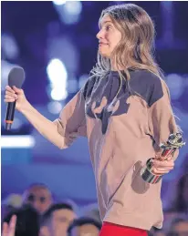  ?? COLE BURSTON • REUTERS ?? Charlotte Cardin reacts as she accepts the award for Album of the Year for "Phoenix" at the 51st annual JUNO Awards in Toronto on Sunday. Cardin took home four awards during the night.