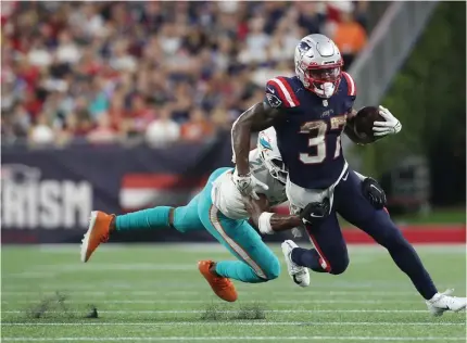  ?? NAncy lAnE / HErAld stAFF ?? ‘NOT GOOD ENOUGH’: Patriots running back Damien Harris looks for room against the Dolphins on Sunday in Foxboro. A late fumble by Harris cost the Patriots a chance at taking the lead and ultimately the game.