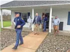  ?? COREY MURRAY/HILLSDALE DAILY NEWS ?? Michigan state troopers leave the Adams Township Hall with a computer tablet seized during the execution of a search warrant on Oct. 29, 2021. A former town clerk and a Michigan lawyer are charged in connection with an alleged voter data breach.