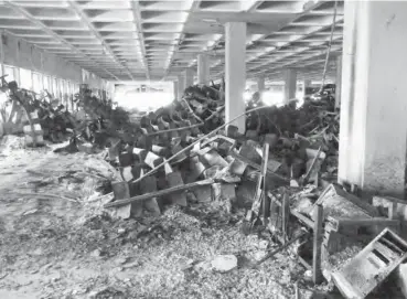  ??  ?? What remains of book shelves at the library