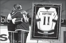  ?? Marcio Jose Sanchez Associated Press ?? KINGS CAPTAIN Anze Kopitar, right, hugged by teammate Drew Doughty in a ceremony for Kopitar’s 1,000th point, built his career on selfless play and defense.
