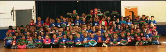 ??  ?? Ted Gocke, J103 Radio Personalit­y, poses with the numerous participan­ts in Ringgold Elementary’s Operation Christmas Child service project.
