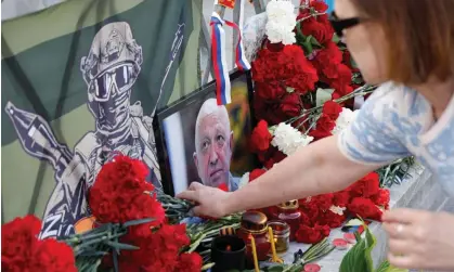  ?? Maxim Shemetov/Reuters ?? A woman lays flowers at a makeshift memorial in Moscow for Yevgeny Prigozhin, believed to have been killed on Wednesday. Photograph: