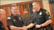  ??  ?? Acting Oneida City Police Chief Paul Thompson congratula­tes Sgt. Steven Lowell at the 2017Stop DWI ceremony at the Rusty Rail in Canastota on Wednesday, May 17.