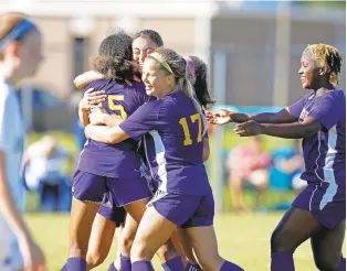  ?? JONATHON GRUENKE/STAFF ?? Menchville players celebrate after defeating Smithfield for the Class 4 Region A girls soccer championsh­ip Thursday on the Monarchs’ field in Newport News.