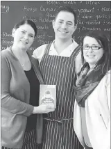  ?? Special to The Herald ?? Theresa Fuller, business banking advisor with Valley First, a division of First West Credit Union, delivers a Fan Choice Award to Lisa Baxter-Burke and John Burke of Front Street Brasserie.The Penticton-based business was recognized in the Best Food &...