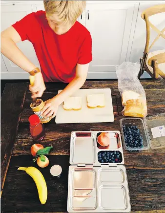  ?? PHOTOS: KATIE WORKMAN/THE ASSOCIATED PRESS ?? Teaching your child kitchen skills action. and having them help with the clean up makes kids feel in on the