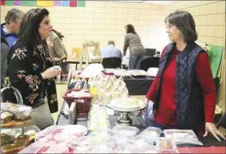  ?? Brodie Johnson • Times-Herald ?? The Newcastle Fire Department’s annual chili day fundraiser not only featured hot bowls of chili, but also a silent auction and baked goods for sale. Regina Gregory, left, speaks with Anita Vandiver about some of the baked goods available during the event.