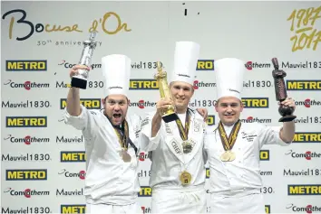  ?? LAURENT CIPRIANI ?? Mathew Peters of the U.S., centre, in 2017 celebrates on the podium after winning the Bocuse d'Or (Golden Bocuse) trophy, in Lyon, central France, ahead Christophe­r William Davidsen of Norway, left, who finished second, and Viktor Andresson of Iceland,...