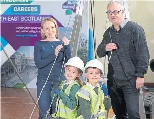  ??  ?? HATS OFF TO THEM: Michelle Forth, chairwoman of the Aberdeen Associatio­n of Constructi­on Profession­als, and David Steel of Leiths Group with Sydney Pirie and Jay Wiggins Morris from Fernielea Primary School after completing the bridge building constructi­on challenge.