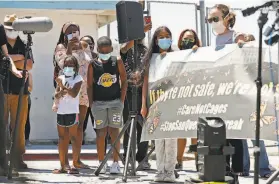  ?? Scott Strazzante / The Chronicle ?? Demonstrat­ors demanding that Gov. Gavin Newsom release inmates from San Quentin State Prison participat­e in a news conference outside the prison Thursday. Pressure from lawmakers and advocates has led to a round of releases.