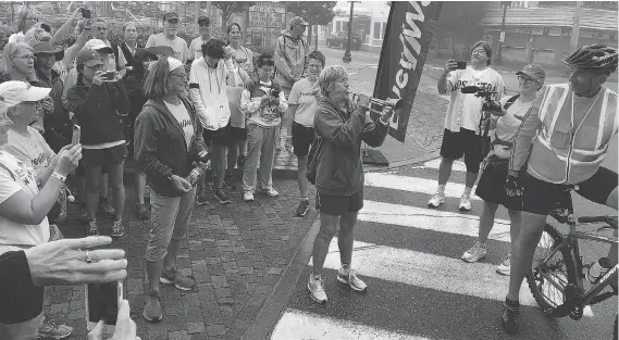  ?? SALLY JENKINS ?? Endurance athlete Diana Nyad rallies her fellow walkers by playing Reveille before the final leg of their journey from Boston to Cape Elizabeth, Maine.