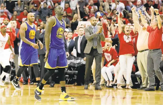  ?? DAVID J. PHILLIP/ASSOCIATED PRESS ?? Draymond Green, center, reacts after the Warriors came up short in Game 3 against the Houston Rockets. Green turned the ball over with one second left to seal Golden State’s defeat.