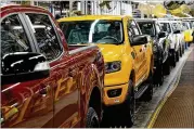  ?? CARLOS OSORIO/AP 2021 ?? The reduction in output includes a 1.3% drop in motor vehicle production as automakers work to keep up with demand while dealing with shortages that have slowed or stopped some vehicle assembly.