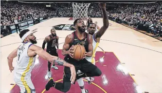  ?? KYLE TERADA THE ASSOCIATED PRESS ?? Cleveland Cavaliers centre Tristan Thompson goes to the basket. The Canadian player says that — even without LeBron James — the Cavs are still the team to beat in the East.