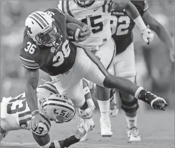  ?? Butch Dill / The Associated Press ?? Auburn running back Kamryn Pettway (36) tries to get by LSU safety Jamal Adams during the first half of Saturday’s game.